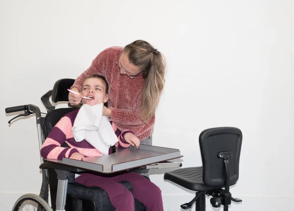 nurse feeding a disabled women