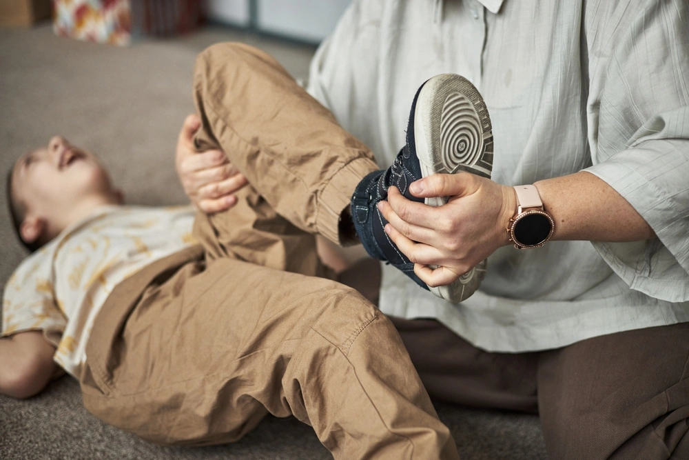 disabled young boy in physiotherapy session