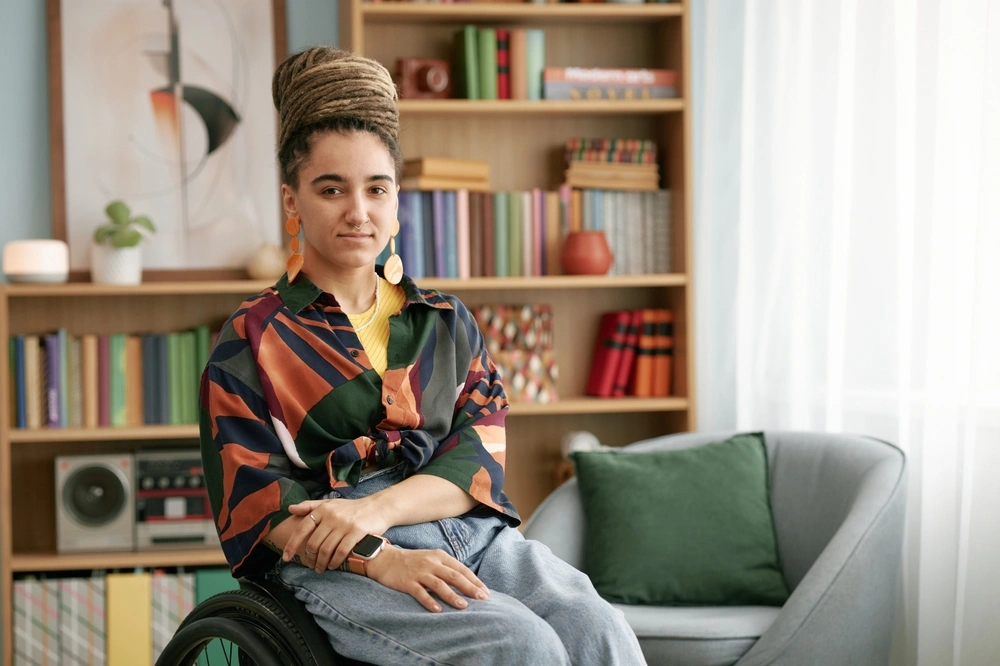 portrait of a disabled women in her home sitting on a wheelchair